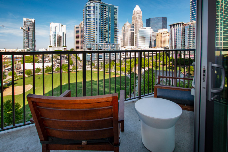 Clubhouse balcony with dual seats overlooking the lawn and downtown